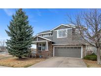 Charming two-story home with gray siding, brick accents, and a well-manicured front yard at 24677 E Florida Ave, Aurora, CO 80018