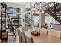 Open dining area with tall ceilings, stylish lighting, and unique bike rack at 3100 Huron St # 4Q, Denver, CO 80202