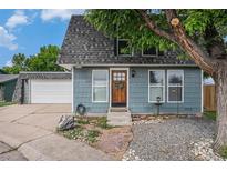 Charming home showcasing a lovely wood door, beautiful landscaping, and an inviting facade at 14753 E Alabama Pl, Aurora, CO 80012