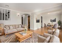 Bright living room featuring hardwood floors, neutral colors, and stylish furnishings at 14753 E Alabama Pl, Aurora, CO 80012