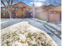 Attractive exterior of a two-story townhome with snow-covered landscaping and attached garage at 9010 W 88Th Cir, Westminster, CO 80021