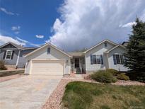 Charming single-Gathering home with well-maintained front yard and attached two-car garage in a quiet neighborhood at 17145 Park Trail Dr, Monument, CO 80132