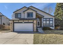 Charming two-story home with stone accents, a two-car garage, and well-maintained lawn in a suburban neighborhood at 5331 S Dunkirk Way, Centennial, CO 80015