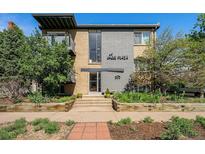 Charming two-story building with brick and gray exterior with manicured landscaping and brick walkway leading to the entrance at 200 N Sherman St # 2, Denver, CO 80203