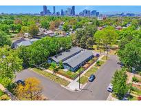 Aerial view of the property in a residential neighborhood, with downtown in the background at 2955 N Gilpin St, Denver, CO 80205