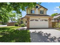 Charming two-story home with a manicured front yard, and a two car garage, showing great curb appeal at 9564 Cordova Dr, Highlands Ranch, CO 80130