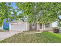 Charming single Gathering home with a two car garage, brick accents and inviting front porch at 10441 Routt Ln, Broomfield, CO 80021