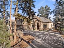 Two-story home with stone accents and a large driveway at 5224 Knobcone Dr, Castle Rock, CO 80108