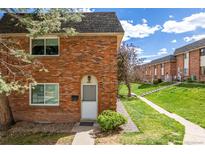 Charming brick townhouse featuring a well-maintained lawn and inviting front entrance at 4663 S Lowell Blvd, Denver, CO 80236