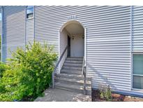 Inviting entrance with steps leading to the front door and units with a well maintained landscaped bush at 11101 E Alameda Ave # 202, Aurora, CO 80012