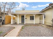Charming home with a covered porch, metal door, and gravel landscaping at 4764 High St, Denver, CO 80216
