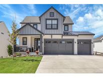 Charming two-story home with a three-car garage and a well-manicured front yard at 1174 Williams Loop, Elizabeth, CO 80107