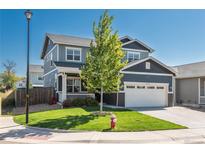 Charming two-story home with a well-manicured lawn, attached two car garage, and a welcoming front porch at 7958 Tejon St, Denver, CO 80221