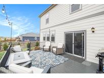 Back deck with outdoor furniture and a view of the backyard at 8395 E 132Nd Pl, Thornton, CO 80602