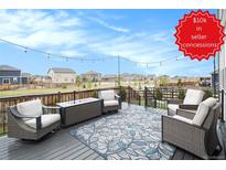 Outdoor back deck area with outdoor seating and nice neighborhood view at 8395 E 132Nd Pl, Thornton, CO 80602