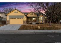 Charming single Gathering home featuring a two-car garage, stone accents, and a well-maintained front yard at 12776 Yates Cir, Broomfield, CO 80020