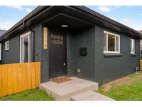Charming brick home showcasing a black painted facade, modern address numbers, and inviting front entrance at 3379 Krameria St, Denver, CO 80207