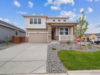 Charming two-story home with stone accents, covered porch, and well-maintained landscaping at 45910 Gentry Ave, Bennett, CO 80102