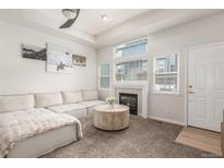 Spacious living room featuring a cozy fireplace and comfortable sectional sofa at 12035 Leyden St, Brighton, CO 80602