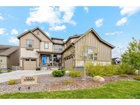 Beautiful two-story home with landscaping and driveway at 9572 Taylor River Cir, Littleton, CO 80125