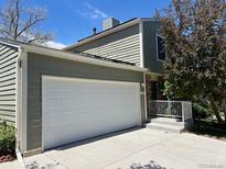 Exterior view of home featuring attached two-car garage and freshly painted siding at 3961 S Uravan St, Aurora, CO 80013