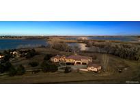 Stunning aerial view of the property with a lake and mature trees on a sprawling lot at 2102 Shoreside Dr, Berthoud, CO 80513