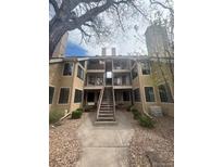 Multi-level condo with walkway and patio, neutral siding with dark window trim at 4876 E Kentucky Ave # F, Denver, CO 80246