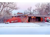 Brick ranch home with carport, snow covered yard at 5420 Manitou Rd, Littleton, CO 80123