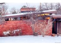 Brick midcentury modern home with snow-covered landscaping at 5420 Manitou Rd, Littleton, CO 80123