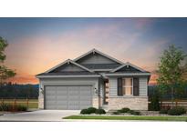 Two-story craftsman style home with gray siding, stone accents and a two-car garage at 3361 N Buchanan Way, Aurora, CO 80019