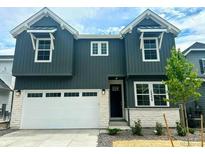 Two-story home featuring a modern exterior, two-car garage, and well-maintained landscaping at 13358 Blue Amber Ct, Parker, CO 80134
