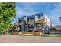 Modern townhome exterior featuring balconies and a contemporary design with a well-kept lawn and street view at 2790 W 25Th Ave # 6, Denver, CO 80211