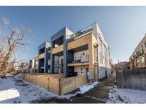 Modern townhomes showcasing a contemporary design, private balconies, and a well-maintained wooden perimeter fence at 2790 W 25Th Ave # 6, Denver, CO 80211