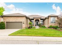 Beautiful stone and stucco home featuring an attached garage and professionally landscaped yard at 12467 Topaz Vista Way, Castle Pines, CO 80108