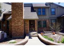 Charming brick townhouse with a well-maintained front yard and inviting entrance at 7920 E Phillips Cir, Centennial, CO 80112