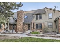 Charming home exterior featuring a brick facade, walkway, and well-maintained landscaping at 7920 E Phillips Cir, Centennial, CO 80112