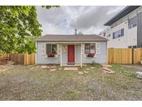 Charming single-story home with a vibrant red front door and decorative flower boxes at 1680 Simms St, Lakewood, CO 80215