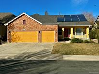 Charming two-story brick and siding home with a two-car garage, solar panels, and a well-maintained lawn at 6596 Silverleaf Ave, Firestone, CO 80504
