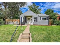 Charming single-story home with gray siding, a well-manicured lawn, and a welcoming front entrance at 4848 Hooker St, Denver, CO 80221