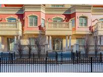 Brick townhome exterior with balconies and wrought iron fence at 1950 N Logan St # 102, Denver, CO 80203