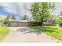 Charming single Gathering home with a brick exterior and a spacious two car garage at 13990 Berry Rd, Golden, CO 80401