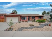 Charming single story home with a two car garage and xeriscaped front yard and walkway at 2140 S Youngfield St, Lakewood, CO 80228
