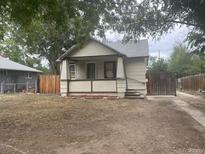 A charming single-story house with a covered porch and a cozy, welcoming facade at 2771 W 1St Ave, Denver, CO 80219