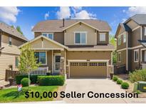 Charming two-story home with a manicured lawn, inviting front porch, and two-car garage at 2948 Open Sky Way, Castle Rock, CO 80109