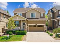 Charming two-story home features a well-manicured lawn and attached two-car garage at 2948 Open Sky Way, Castle Rock, CO 80109