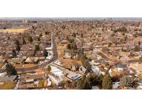 Stunning aerial view of a home with an in-ground pool nestled in a neighborhood with city views at 434 S Newport Way, Denver, CO 80224