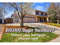 Charming two-story home featuring a two-car garage, inviting front porch and mature trees in a well-manicured yard at 1479 S Jasper St, Aurora, CO 80017