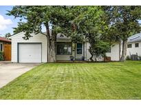 Charming single-story home featuring a well-maintained lawn and an attached one-car garage at 1924 Yosemite St, Denver, CO 80220