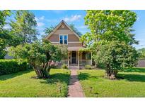 Charming home with a covered front porch and mature landscaping along a stone walkway at 3039 W 22Nd Ave, Denver, CO 80211