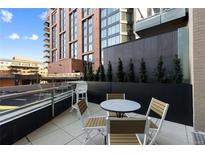 Relaxing outdoor patio with a table, chairs, and beautiful plantings at 1901 Wazee St # 312, Denver, CO 80202